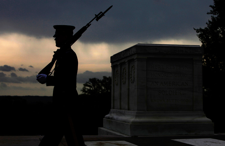 A soldier from the U.S. Army's Old Guard honor guard walks at the Tomb of the Unknowns at Arlington National Cemetery in Arlington