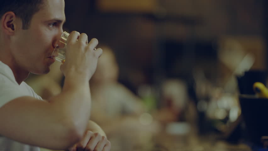 man sitting at bar drinking